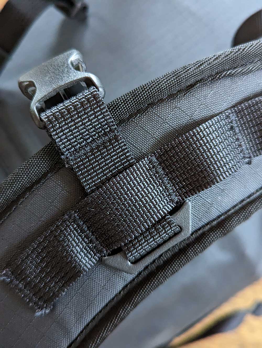 showing a closeup of the Big River Dry Backpack's shoulder strap and daisy-chain.