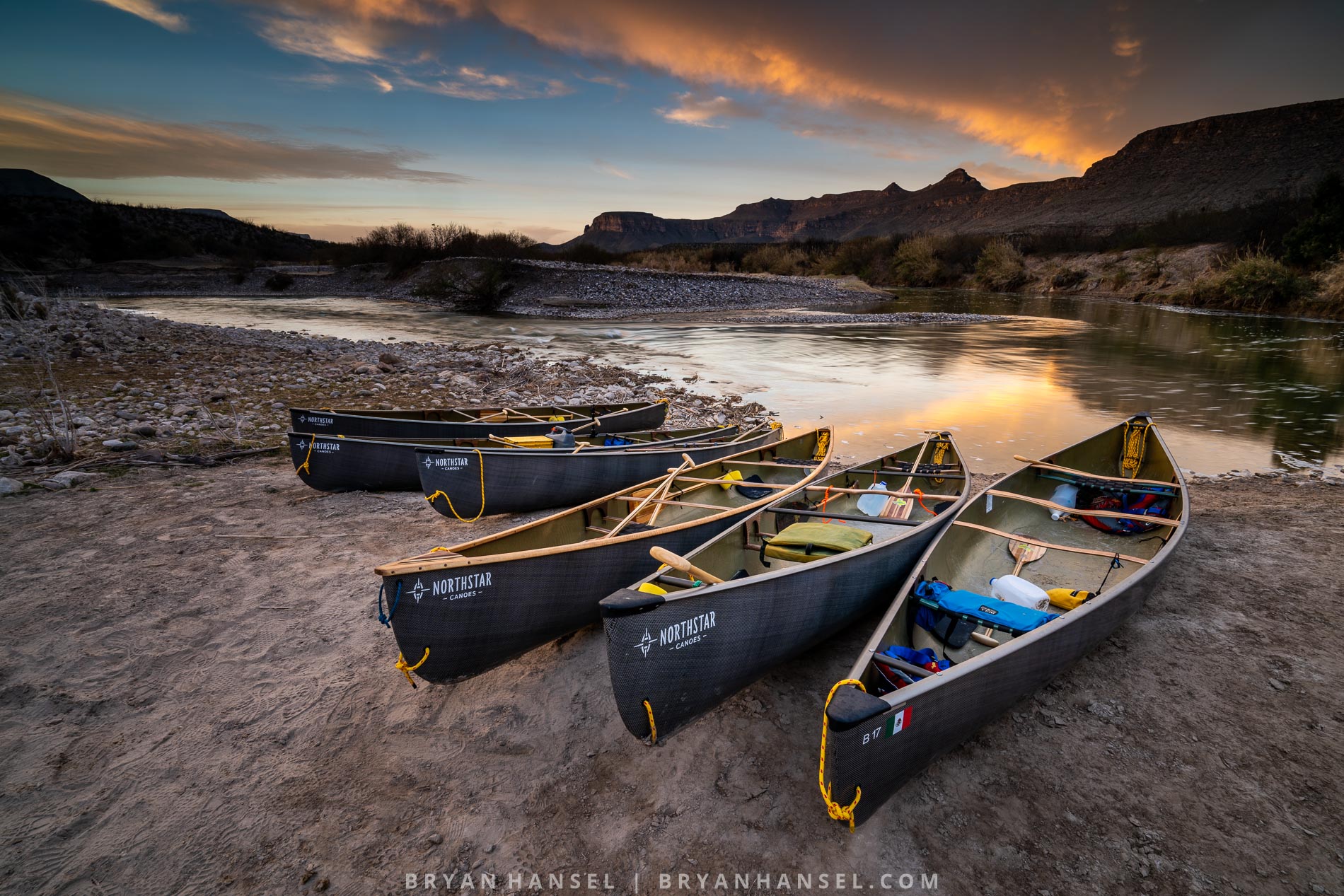 Five carbon fiber canoes on the Rio Grande River at sunrise